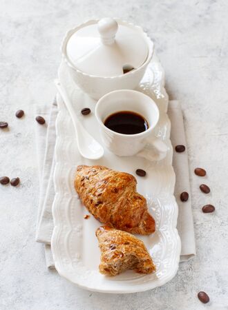 Romantic breakfast tray with coffee cup and croissant close upの写真素材