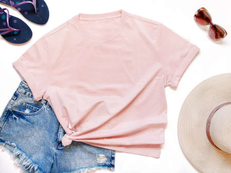 Mockup of a pink t-shirt placed between some beach accessories flat layの写真素材