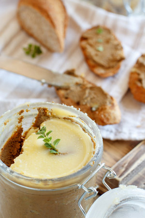 Sandwiches with homemade liver pate and Jar of pate on a table