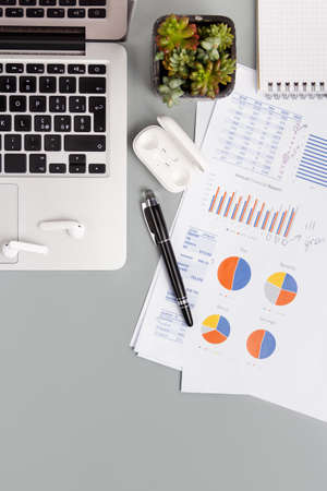 Laptop and modern gadgets on a grey office desk top view. Business conceptの写真素材