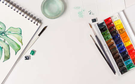 Drawings, brushes, palette and watercolor paints top view. Workplace of artistの写真素材