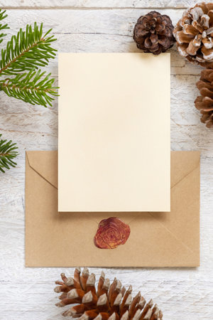 Winter Christmas Composition with a card over sealed envelope flat lay. Christmas and New Year...