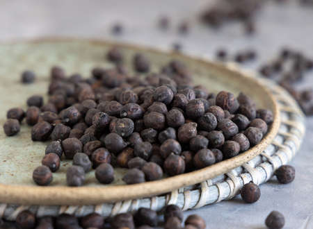 Plate of dry black chickpea from Apulia and Basilicata in Italy on grey table with copy space, closeupの写真素材
