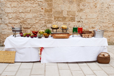 Rural reception table served with various food and drinks for birthday party or wedding. Assortment...