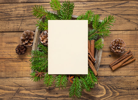 Winter Christmas Composition with a blank card and sealed envelope on wooden table. Christmas and...