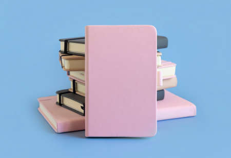 Stack of pink and grey hardcover notebooks on light blue closeup.  Textbook mockup, planner cover with place fot text. Educational, business and organizing conceptの写真素材