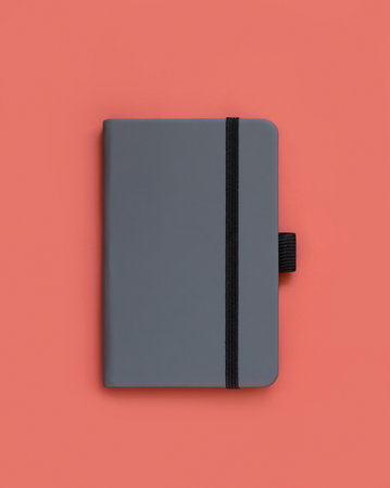 Grey hardcover notebook on red top view. Textbook cover mockup, planner cover with place fot text. Educational, business and organizing conceptの写真素材