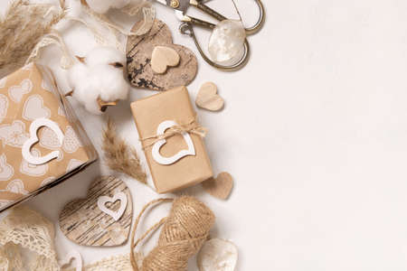 Valentines Day presents wrapped in kraft paper and decorated with vintage lace, hearts and pampass grass top view. Spring rustic, cottage chic or bohemian conceptの写真素材