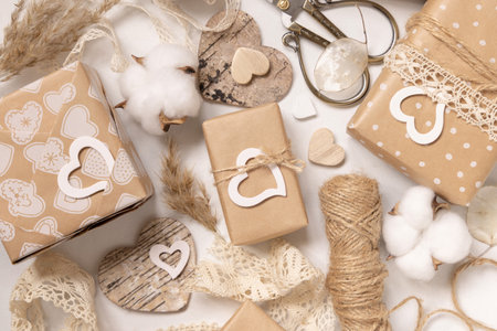 Valentines Day presents wrapped in kraft paper and decorated with vintage lace, hearts and pampass grass top view. Spring rustic, cottage chic or bohemian conceptの写真素材
