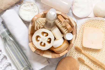 Sauna bucket with organic natural cosmetics and zero waste reusable accessories for skin and hair care flat lay. Top view of eco friendly beauty products for bath, massage or spa salonの写真素材