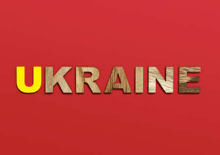 Ukraine, word written in colorful wooden alphabet letters on red background. The concept of a terrible war for independence. Top view. Copy spaceの写真素材