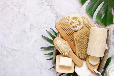 Homemade organic cosmetics and eco friendly accessories near monstera leaves flat lay, copy space....