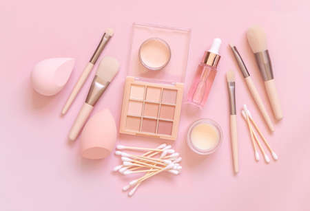 Skin care and makeup products on light pink, top view, banner. Flat lay with natural beauty products and decorative cosmetics. Everyday woman face care routine. Pastel compositionの写真素材