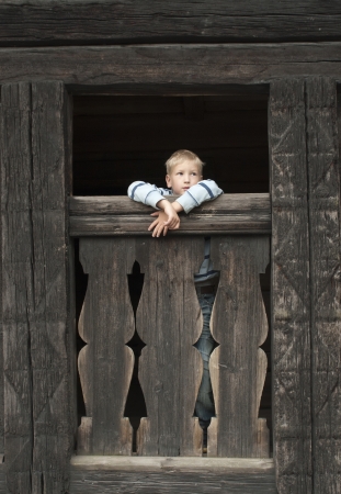 boy in the old wooden houseの写真素材