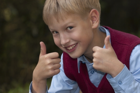 smiling boy  giving thumbsの写真素材