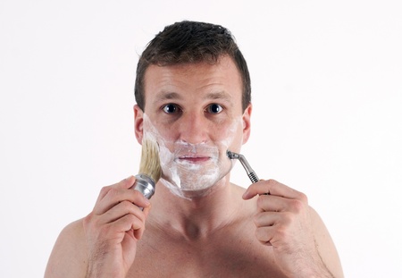 The young man with accessories to shaving.  Isolated on a white background の写真素材