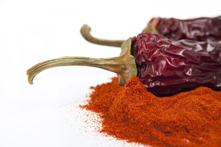 Close-up Red dry chili pepper and heap of the red peppery spice  Isolated on the white