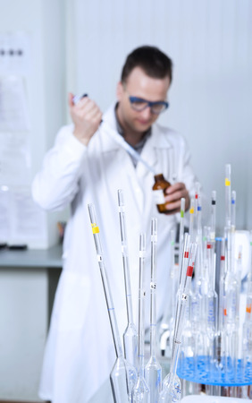 Male scientist with laboratory pipettesの写真素材