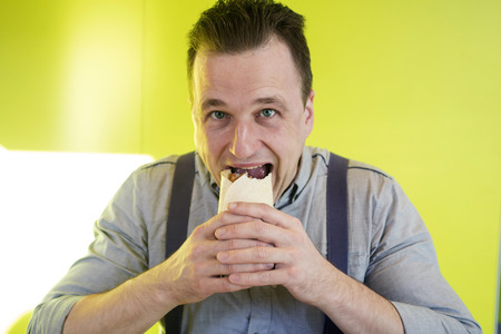 Man eats a sandwichの写真素材