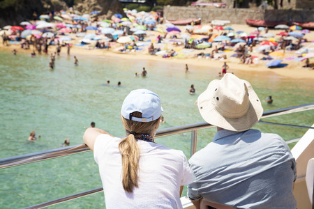 couple looking to shore from a boatの写真素材