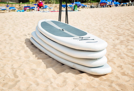 White plastic surfboards on a sandの写真素材