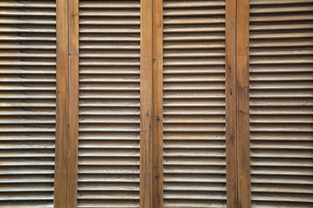 Brown, wooden, vertical completely covered blinds as a background. Horizontal top view shot with space for text.の写真素材