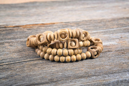 Single wooden bead bracelets on wood tableの写真素材