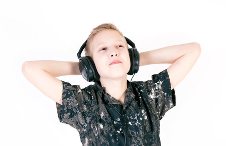 Teenager listening music with headphones, isolated on white background.の写真素材