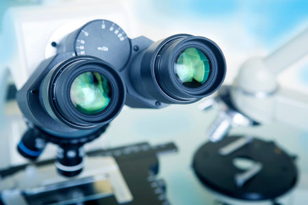 Professional ocular laboratory microscope with stereo eyepiece close-up.