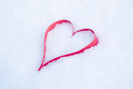 Heart in a snow-covered snowdrift. Concept of Christmas and Valentine's Dayの写真素材