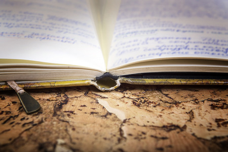 Ancient notebook with records on an old  background. Antiquarian books.の写真素材