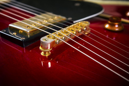 Red acoustic guitar close up in dark backgroundの写真素材