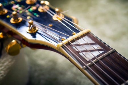 Red acoustic guitar close up in dark background