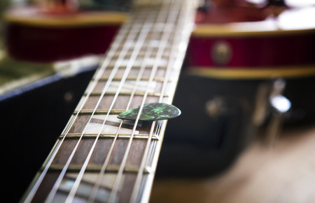 Red acoustic guitar close up in dark backgroundの写真素材