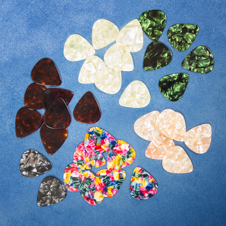 Guitar plectrums isolated on a blue backgroundの写真素材