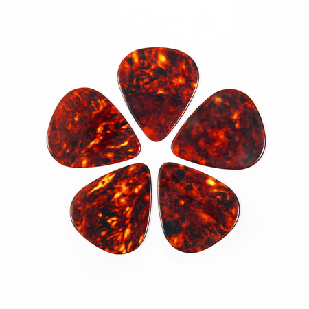 Red guitar plectrums isolated on a white backgroundの写真素材