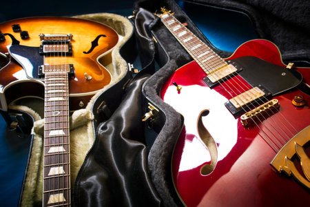 Acoustic guitars in covers in a blue backgroundの写真素材