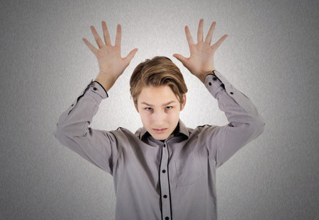 Teenager shows hands signsの写真素材