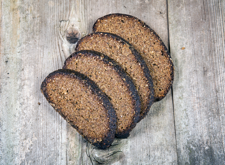 Black bread on a wooden background