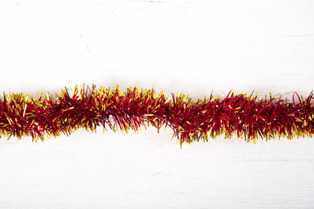 Christmas decoration.Red garland on white wooden background.の写真素材