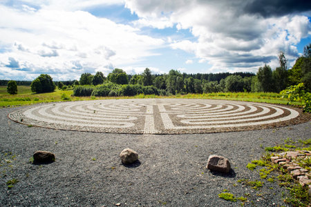 Gothic labyrinth from black and white cobble-stones in the field. Europe. Letonia. Symbol of a new...