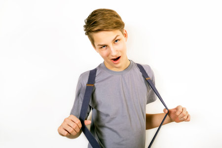 Teenager in a gray shirt plays the foolの写真素材