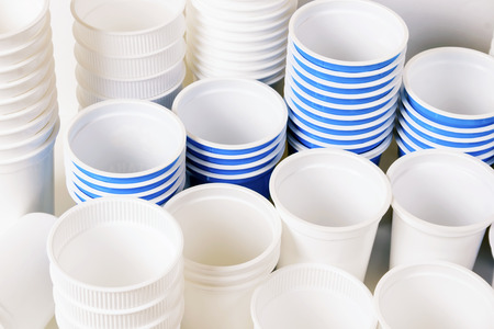 Empty white and blue food plastic glassesの写真素材