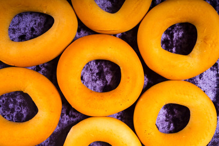 Colorful pattern of bagels on  lilac velvet background. Top viewの写真素材