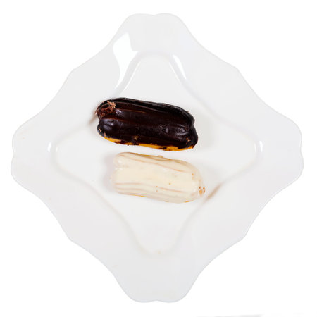 Eclair cakes, on white plate  background.Top view