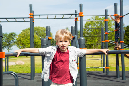 Happy little boy on the playground at the day time