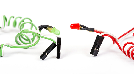 Red and green diodes on helical conductors are isolated on whiteの写真素材