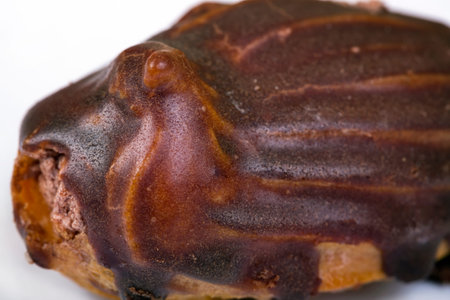 Eclair sweet cakes brown background. Top view