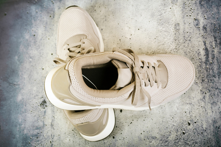Pair of men's sports shoes on a concrete backgroundの写真素材