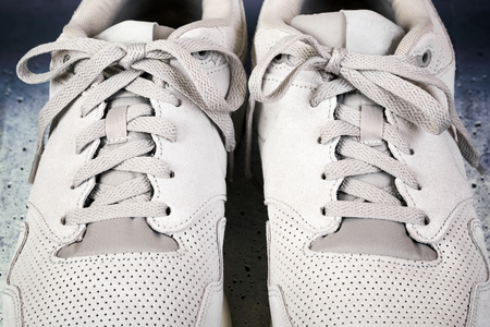 Pair of men's sports shoes on a concrete backgroundの写真素材